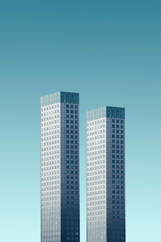 two teal and white skyscrapers